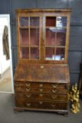 18th Century and later walnut bureau bookcase, the later top section with moulded cornice and two