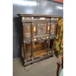 An unusual and highly ornate Italian side cabinet with extensive carved decoration of classical