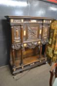 An unusual and highly ornate Italian side cabinet with extensive carved decoration of classical