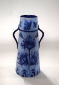 A Moorcroft florian vase, the tapered body with loop handles and typical blue and white florian