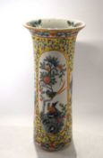 A Chinese porcelain vase, 19th Century, of cylindrical form with polychrome decoration of flowers on
