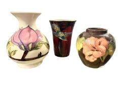 A Moorcroft vase of baluster shape with two blind flowers together with a Moorcroft ginger jar