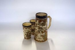 A Japanese Satsuma wear lemonade jug decorated with typical designs together with two matching