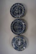 Three small Chinese porcelain bowls all with blue and white designs within brown line rims, Qianlong