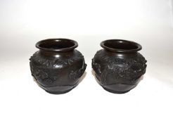 A small pair of Japanese bronze vases with applied design of flowers and birds