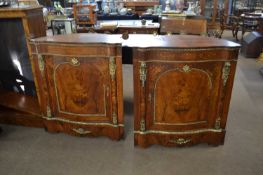 A pair of unusual continental serpentine front and barrel back corner cabinets the single doors