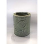 A Chinese vase of circular form, the celadon glaze decorated with fish, 15cm high