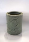 A Chinese vase of circular form, the celadon glaze decorated with fish, 15cm high