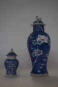 A 19th Century Chinese porcelain vase and cover of baluster form, the blue ground with prunus