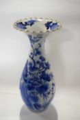 A Japanese porcelain vase decorated with blue and white design of birds amongst branches, 33cm high