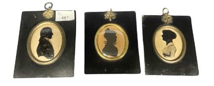 Group of three silhouettes, late 18th/early 19th Century in black wooden frames, one with