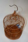 An unusual Chinese wooden bird cage with two Chinese porcelain feeders with blue and white designs