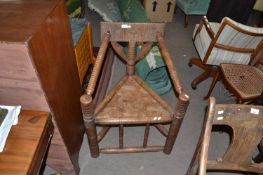 19th Century Turners corner chair with carved detail and a triangular formed seat, 90cm high