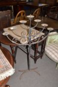 An iron floor standing seven light candelabra or menorah with spreading four footed base, 118cm