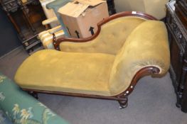 Victorian mahogany framed chaise longue with buttoned upholstery raised on turned legs with casters