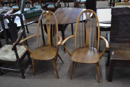 A pair of Ercol swan back carver chairs