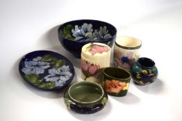 Group of Moorcroft wares including a hisbiscus bowl on brown, small globular anemone vase with paper