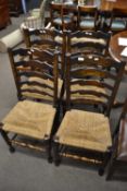 Set of four Lancashire style ladder back dining chairs with rush seats and turned frames