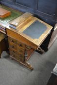 Victorian walnut veneered Davenport desk of typical form with a sloped writing surface opening to