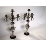 A pair of European five light silver plated candelabra with cherub decoration. - 42 cm high