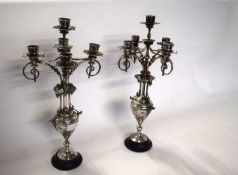 A pair of European five light silver plated candelabra with cherub decoration. - 42 cm high