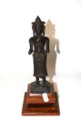 A metal model of a Hindu deity, probably South Indian on wooden plinth 26cm high