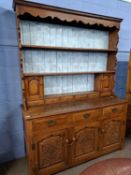 A good quality oak dresser with back section with two shelves and a selection of small drawers and
