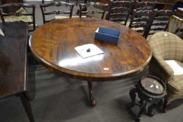 A Victorian rosewood circular top breakfast or dining table raised on a turned and carved column