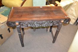 Chinese hardwood alter table, the top with scrolled ends over a pierced fret work panel raised on