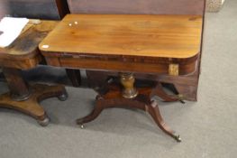 A George IV mahogany fold over tea table raised on a turned column with four outswept legs, 96cm