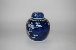 A Chinese porcelain ginger jar and cover, the blue ground with prunus decoration, late 19th/early