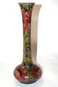 An early Moorcroft vase of slender shape, decorated with the cornflower pattern, 33cm high (