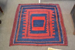 A Middle Eastern flat weave rug decorated with a large central blue and red geometric panel, 110 x