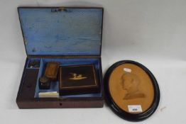 An oval wax relief profile of Bunny Akester (1939) together with a small leather mounted