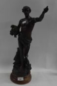 A Spelter model of a classical figure on circular wooden base, 50cm high