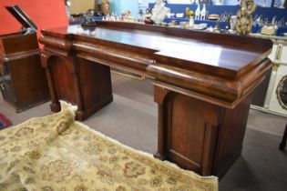A Victorian mahogany pedestal sideboard, the top section with three frieze drawers over two
