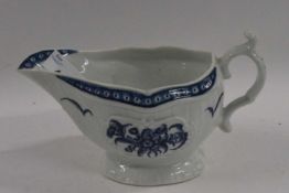 A Worcester porcelain sauce boat with blue and white printed design (crack to rim)