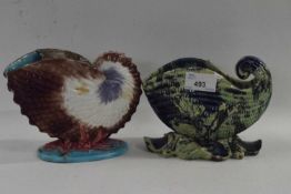 Two Nautilus shell formed spoon warmers, one with a green and blue mottled glaze stamped Dunmore