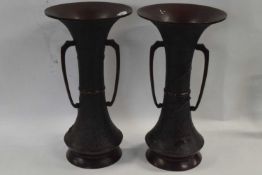 A pair of Japanese bronze vases with flared rims and applied decoration of flowers and birds, 38cm