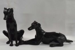 Two Spelter greyhound figures, one of a recumbent greyhound and the other in seated position, 30cm