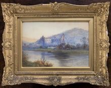 Thomas Hodgson Liddell RBA (British,1860-1925), A view across a lake to church ruins, watercolour,