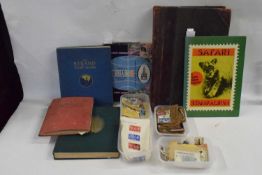 Mixed Lot: Various world stamps contained in various albums, a vintage leather bound ledger book and