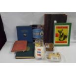 Mixed Lot: Various world stamps contained in various albums, a vintage leather bound ledger book and