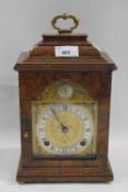 A 20th Century mantel clock in walnut case, silvered dial with gilt design spandrels, the