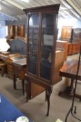 Late 19th or early 20th Century oak corner display cabinet with two glazed doors opening to a