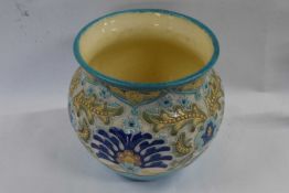 A Burmantofts pottery jardiniere with an incised floral design picked out in blue and yellow below a