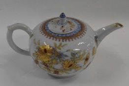 An 18th Century Chinese porcelain teapot and cover with an Imari design (chips to spout, handle