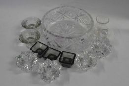 A cut glass fruit bowl containing a number of small other cut glass bowls and other items, the