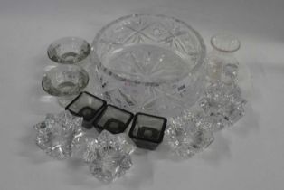 A cut glass fruit bowl containing a number of small other cut glass bowls and other items, the