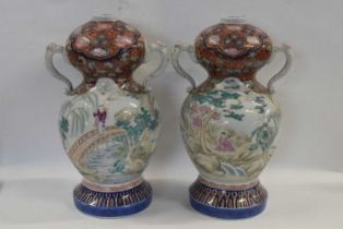 An unusual pair of Japanese porcelain vases of double gourd shape with loop handles, the main body